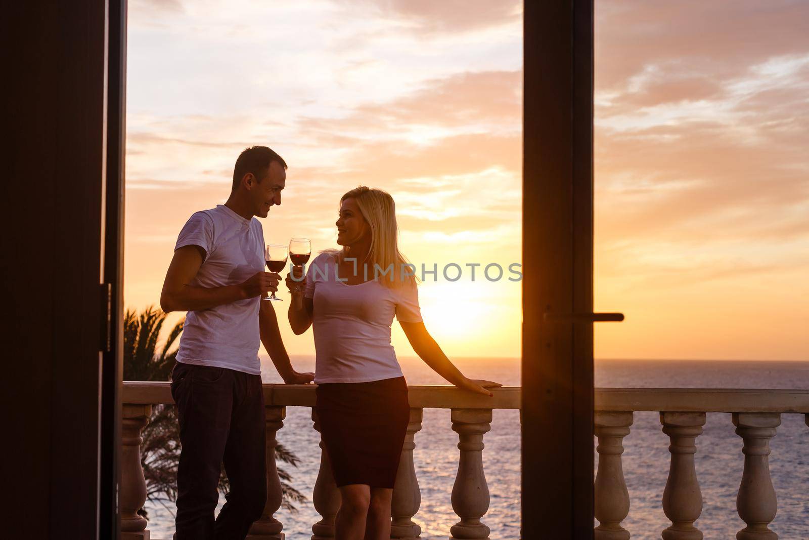 Woman admiring sunset from her balcony