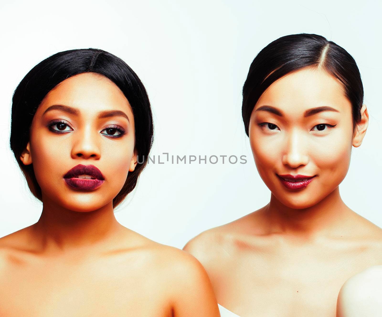 different nation woman: african-american and asian together isolated on white background happy smiling, diverse type on skin, lifestyle people concept close up