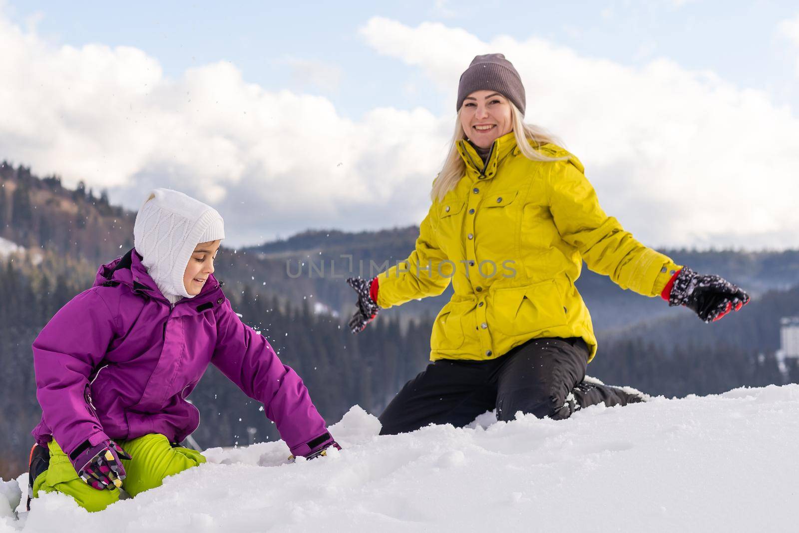Winter,ski, snow and sun - family enjoying winter vacation