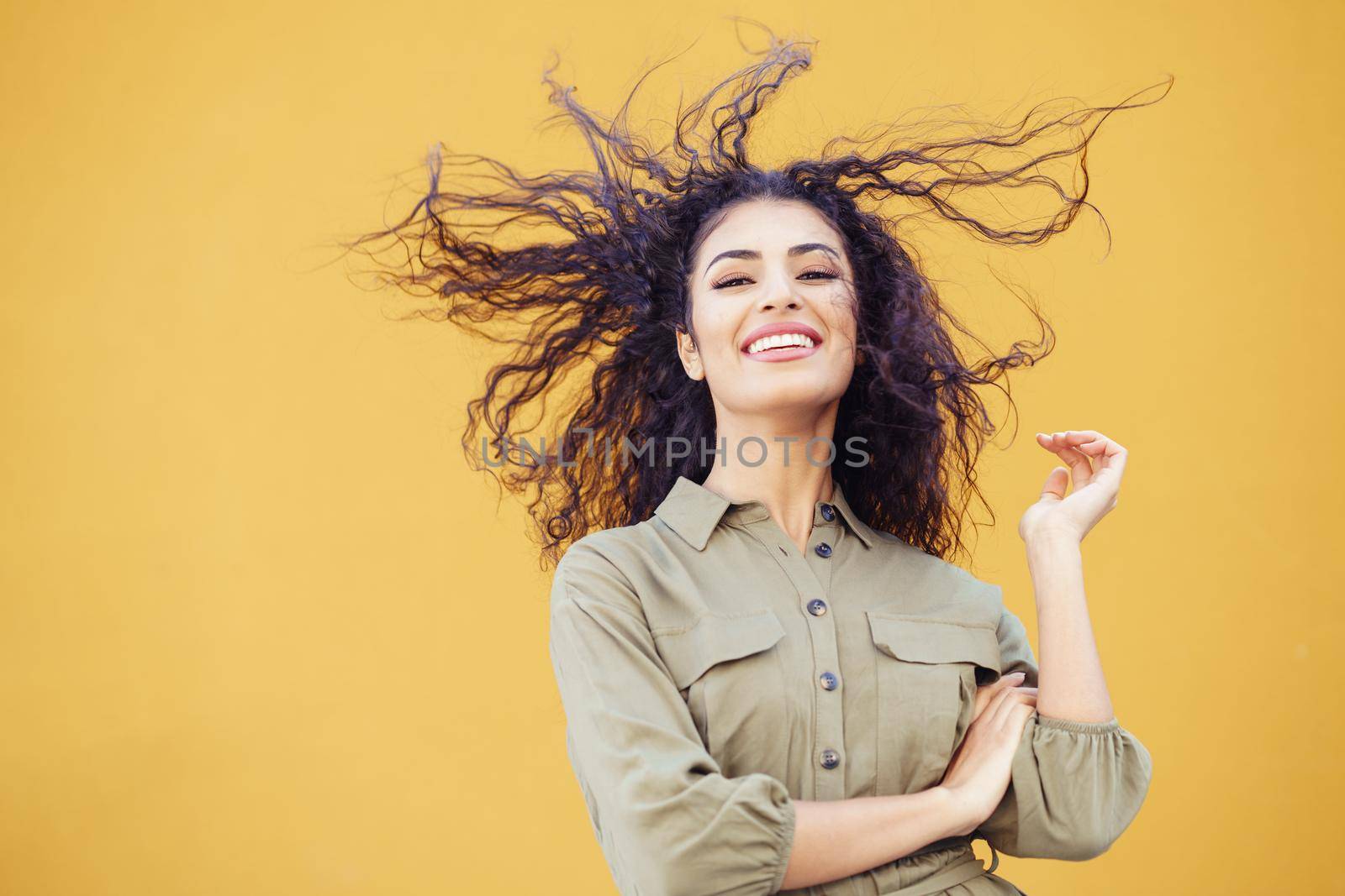 Arab woman with curly hair moved by the wind by javiindy