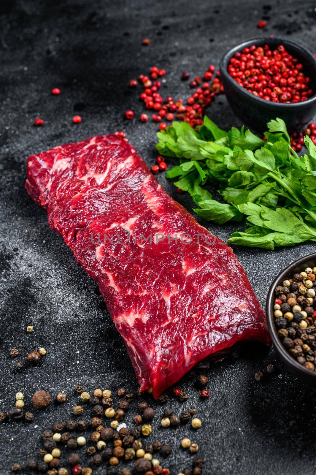 Raw marble beef meat steak. Black background. Top view by Composter