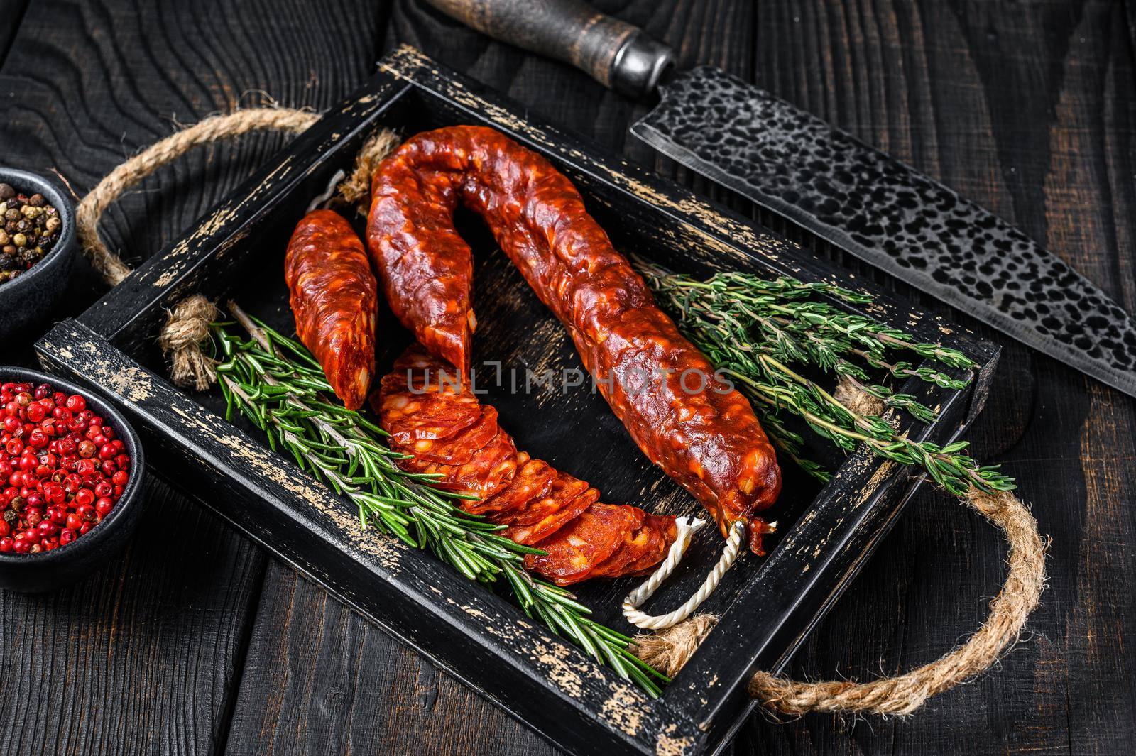 Sliced chorizo salami, Spanish traditional chorizo sausage. Black wooden background. Top view by Composter