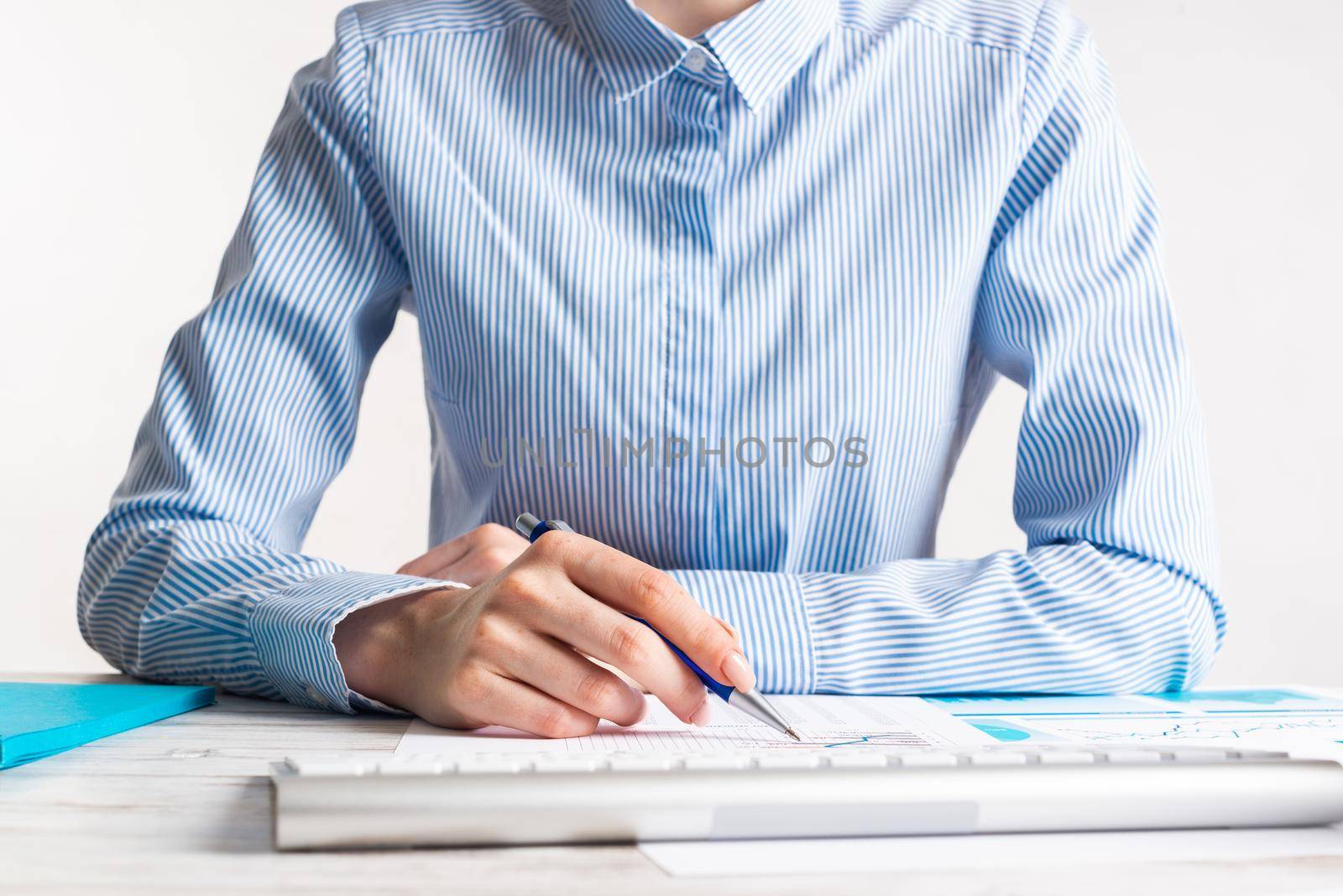 Business consultant sitting at desk and analyze financial report. Strategy planning and investment. Corporate office workplace with analyst at wooden desk. Business accounting and management.
