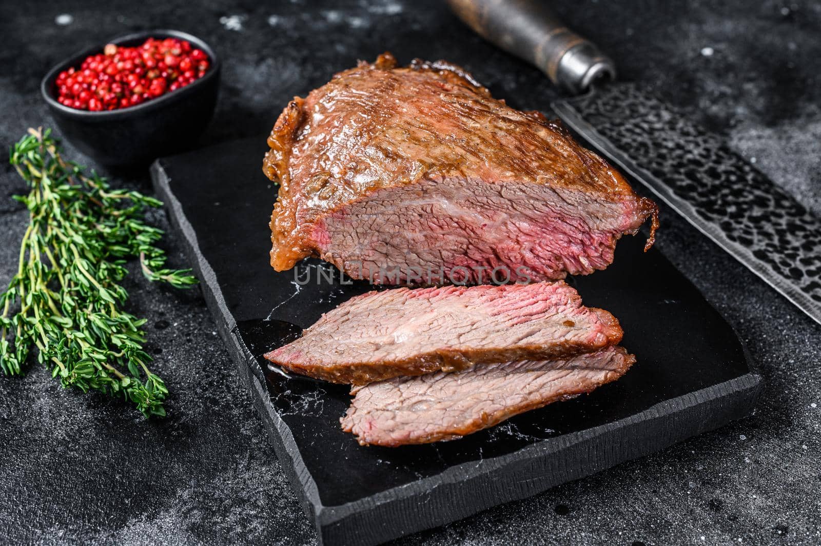 Roast beef tri tip steak bbq. Black background. Top view by Composter