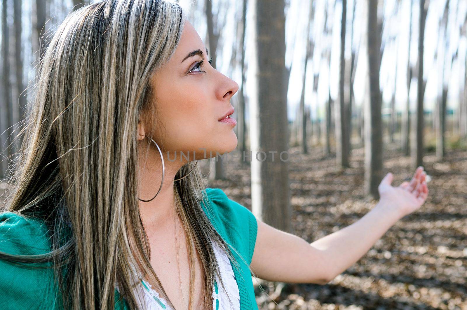 Beautiful blonde girl, dressed in green, into the woods in Fuente Vaqueros, Granada, Andalusia, Spain