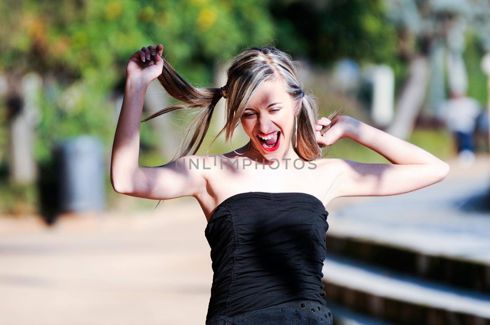 Beautiful and fashion girl with pigtails shouting and dancing by javiindy