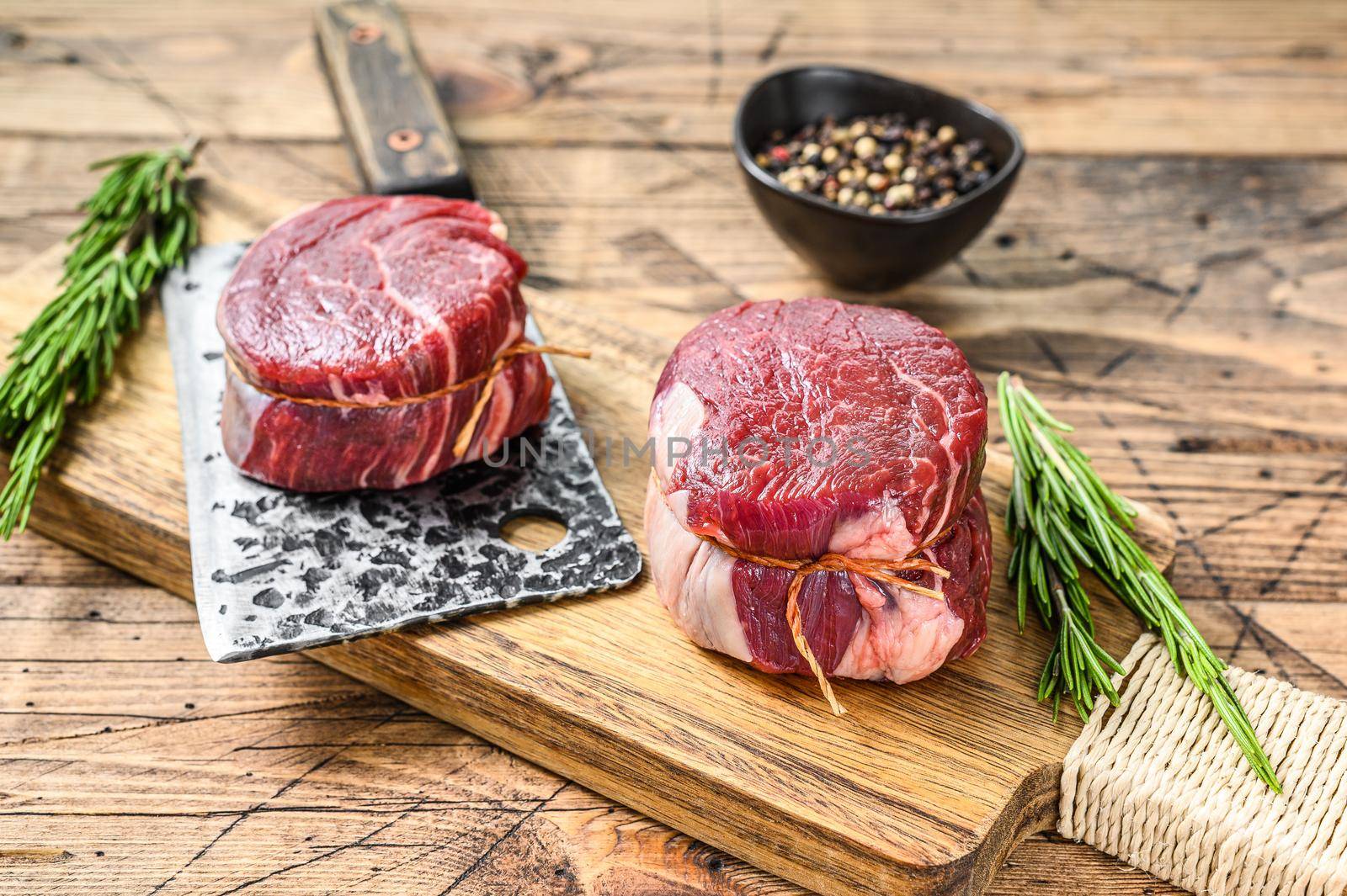 Raw beef meat steak Tenderloin fillet. Wooden background. Top view by Composter