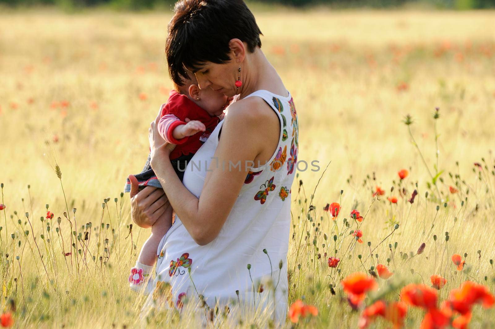 Mother and daughter in a poppy field by javiindy