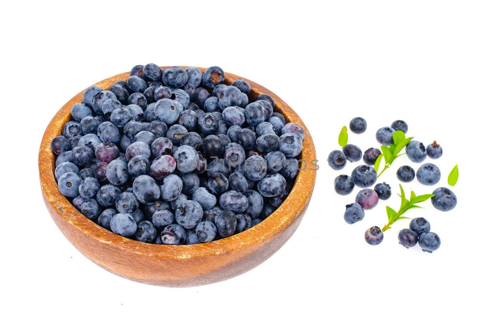 Wooden bowl with blue berry blueberry isolated on white background. Studio Photo
