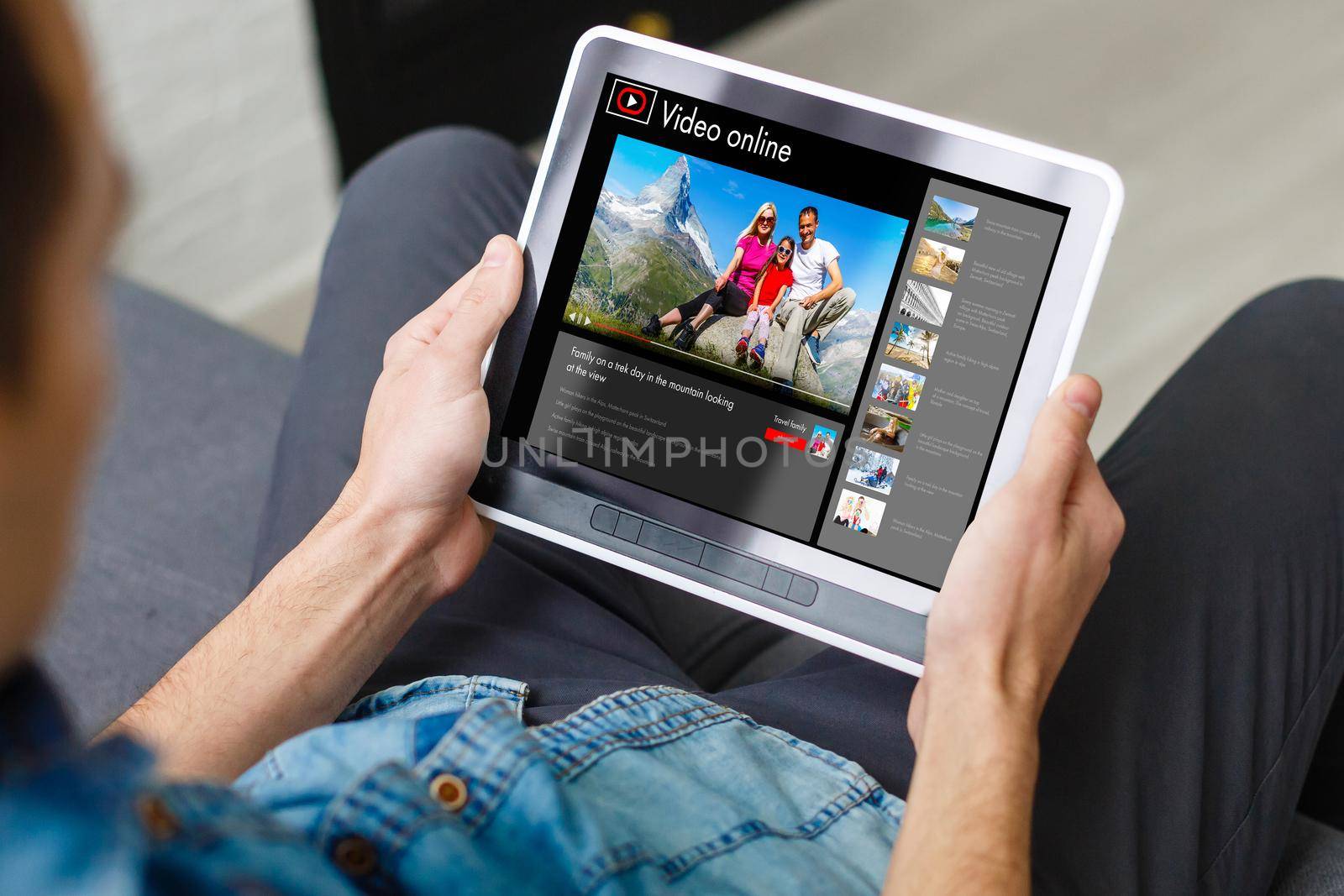 Man watching videos online on tablet by Andelov13