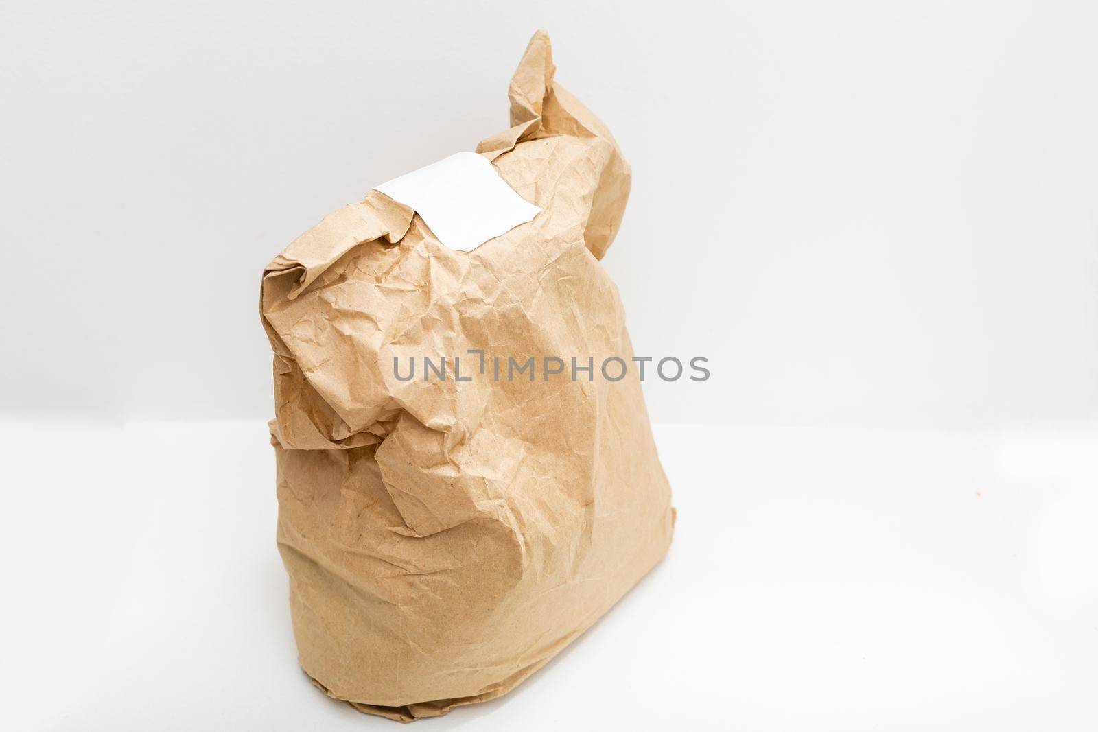 brown clear empty blank craft paper bag for takeaway isolated on white background. Packaging template mock up. Delivery service concept. Copy space. by Andelov13