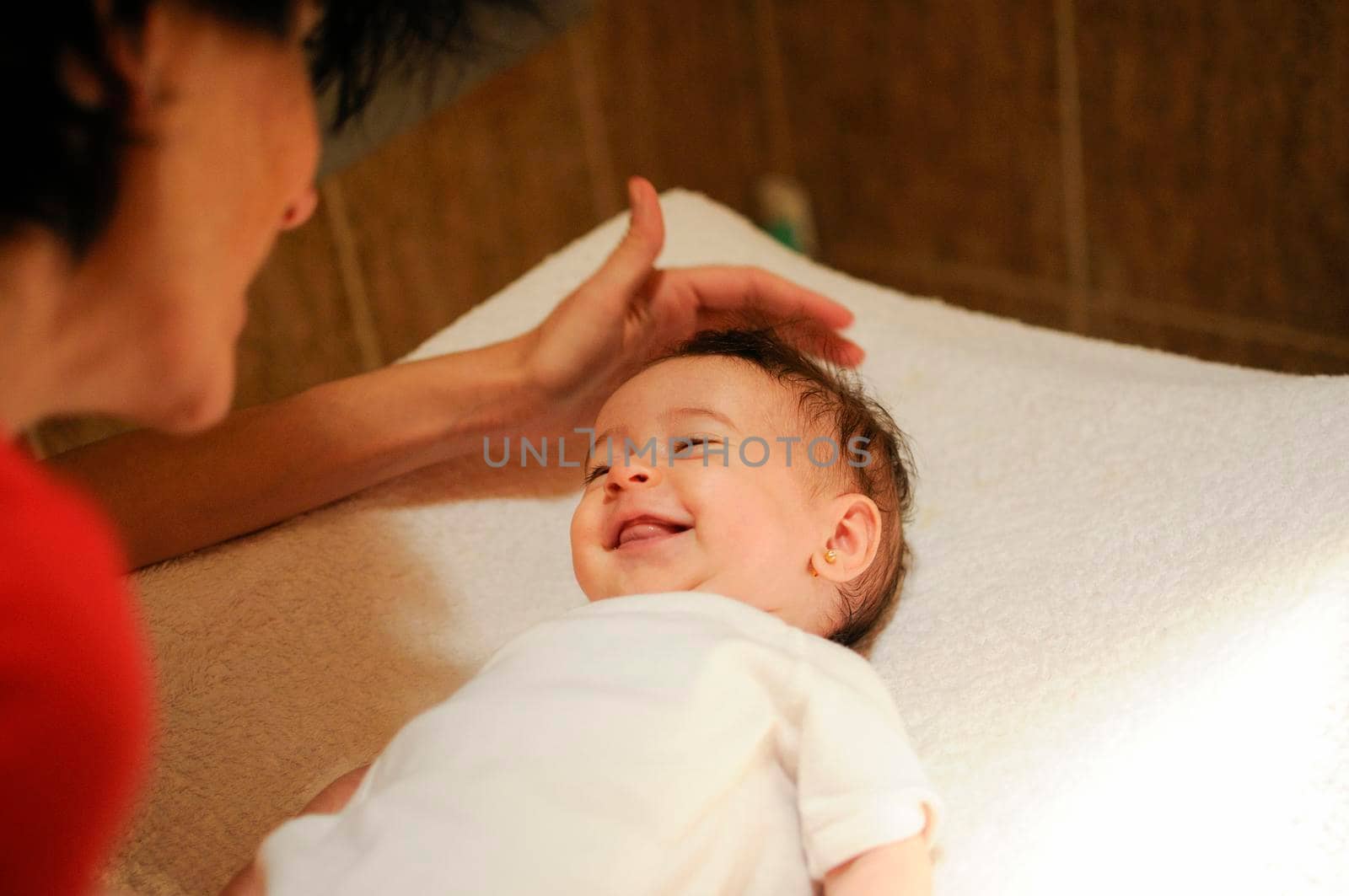 Baby girl two months old smiling to her mother by javiindy