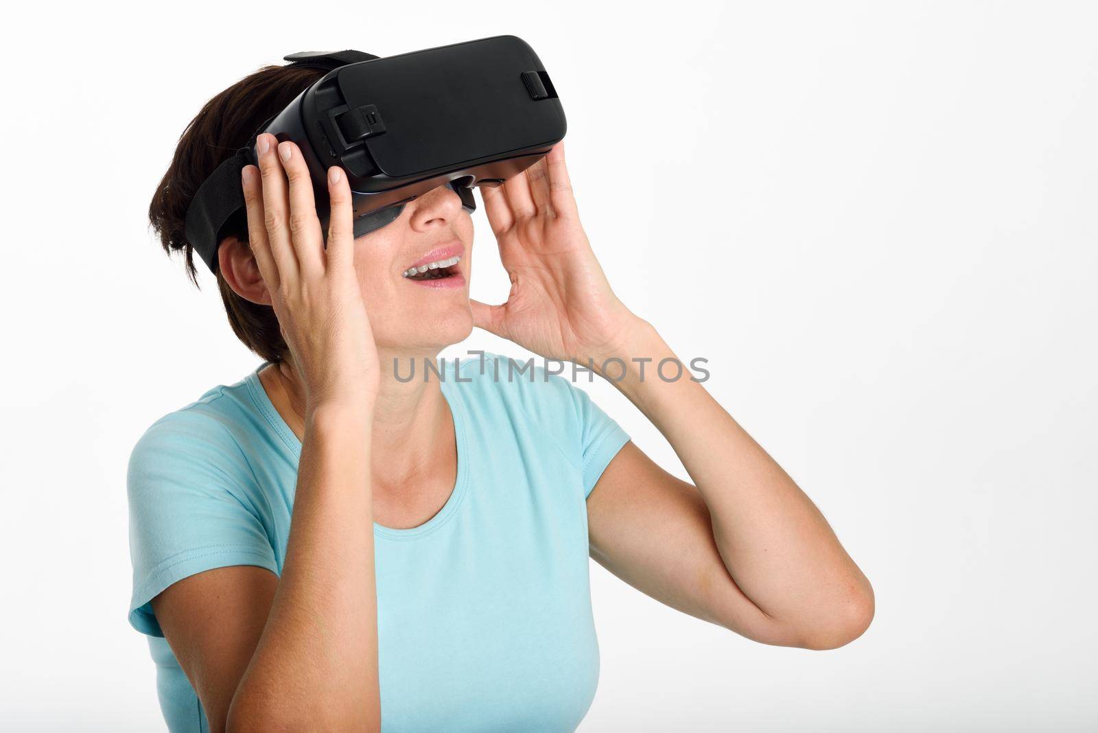 Woman looking in VR glasses and gesturing with his hands. by javiindy