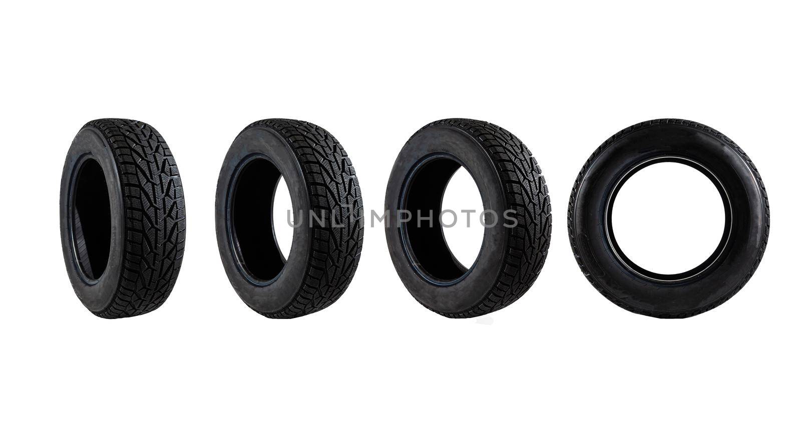 set of black car tires lined up horizontally on white background.