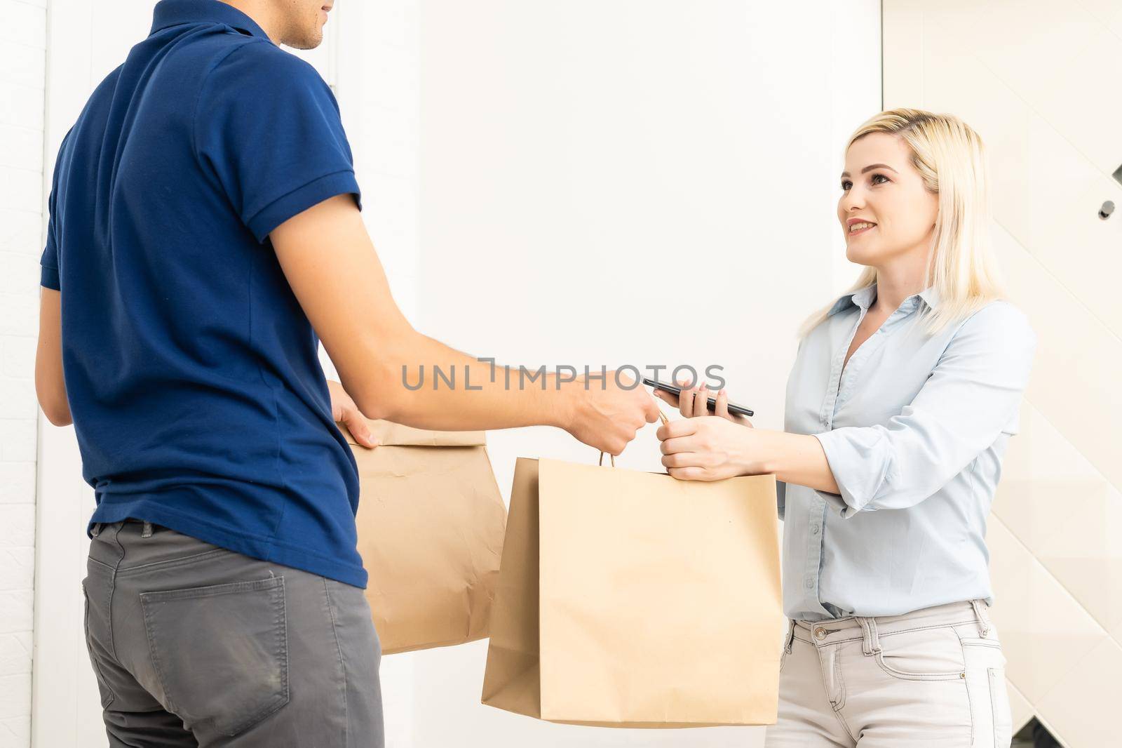 Delivery man holding cardboard boxes. Fast and free Delivery transport . Online shopping and Express delivery . Quarantine by Andelov13