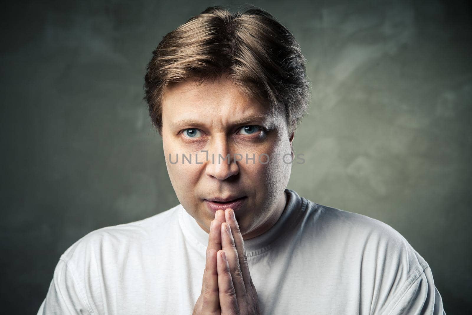 young handsome man doubting over gray background