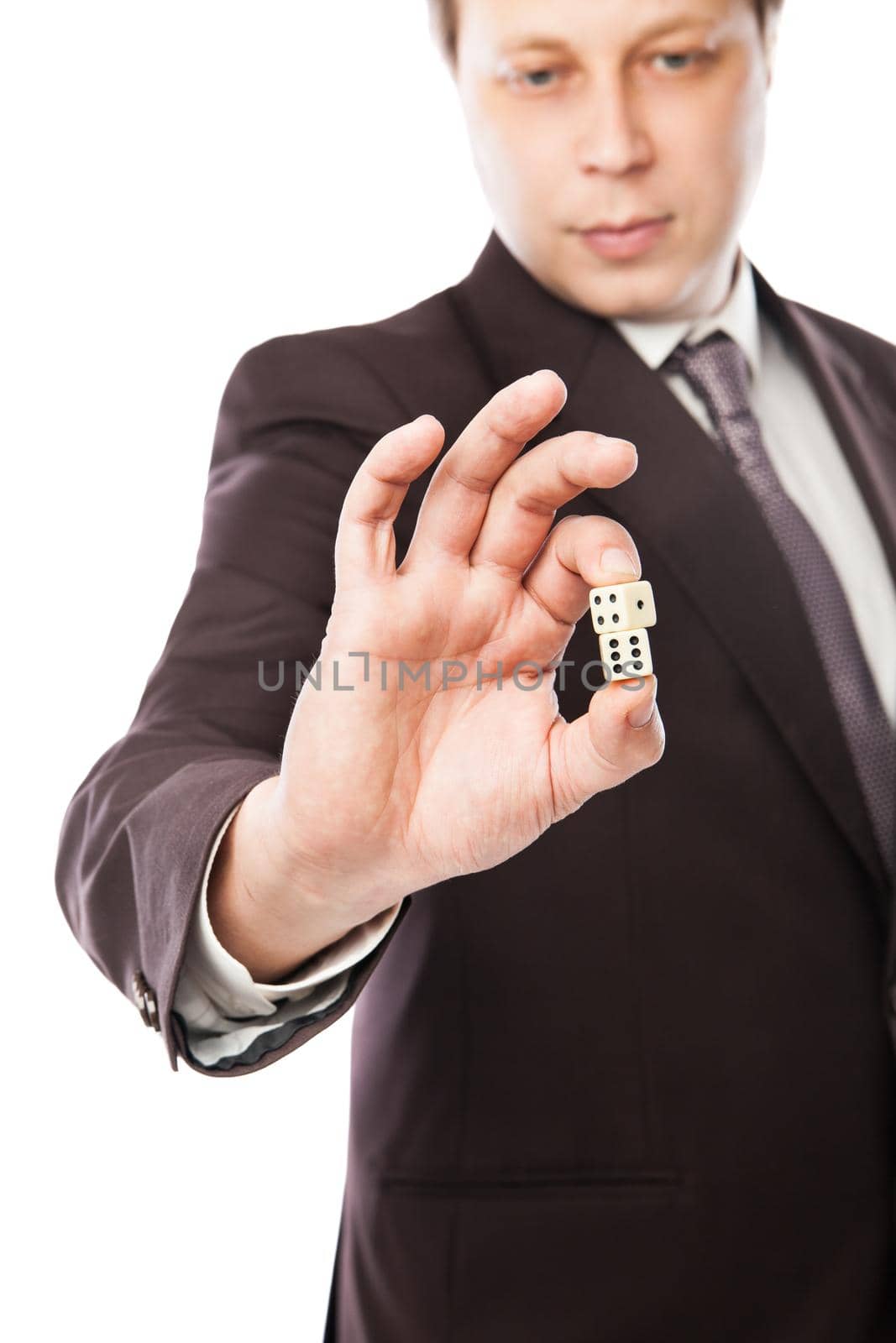 Business risk concept - businessman in suit throwing dices isolated on white background