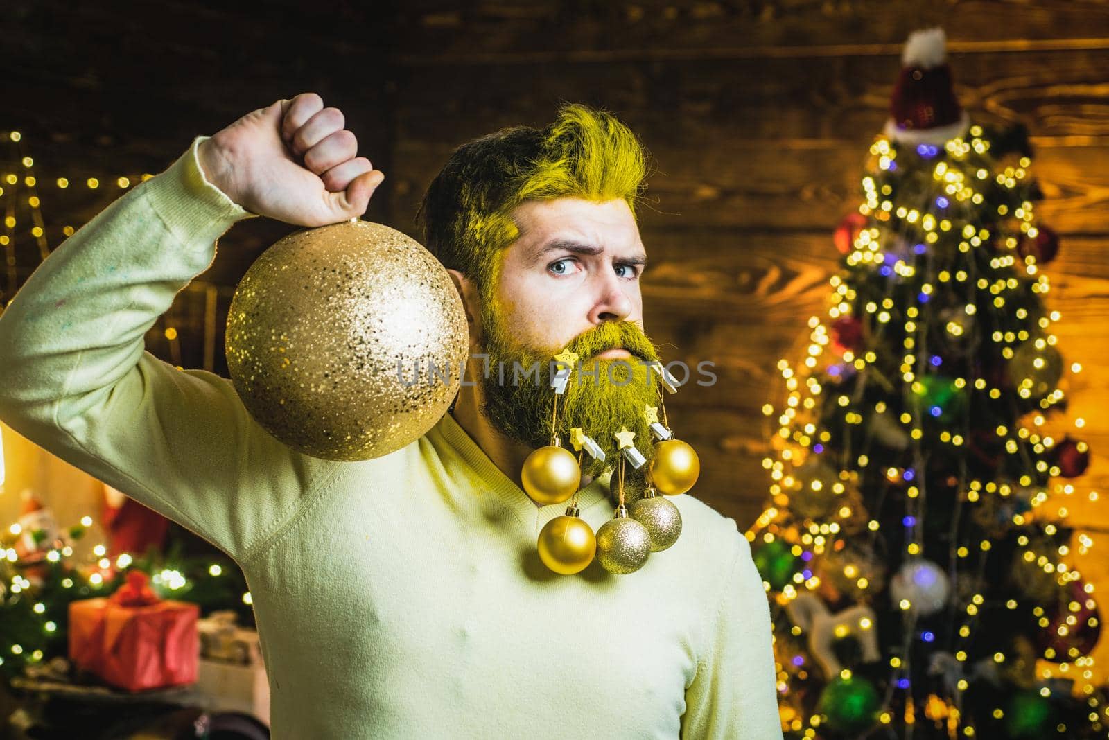 Funny Santa man indoors with Christmas ball, gold bauble. Santa winter portrait. Winter emotion. Christmas preparation