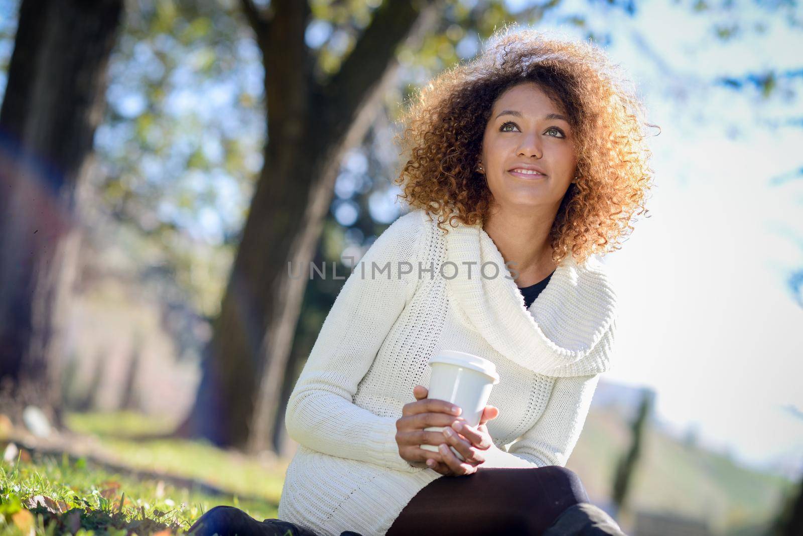 Young African American girl with afro hairstyle with coffee cup by javiindy