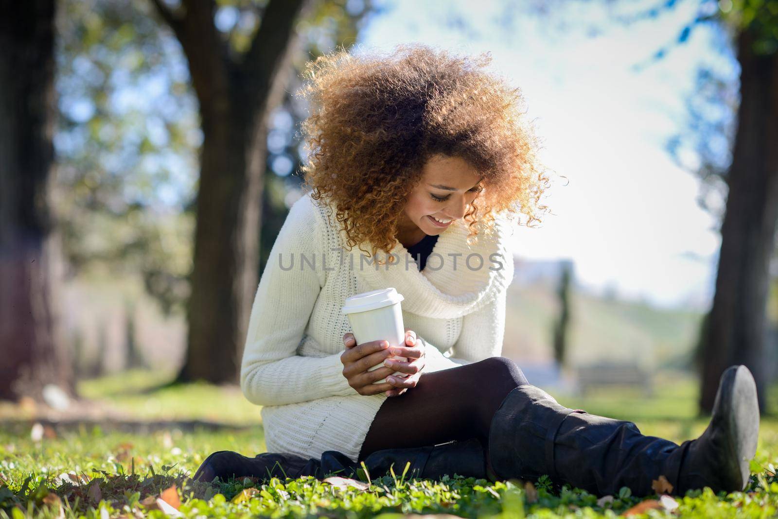 Young African American girl with afro hairstyle with coffee cup by javiindy