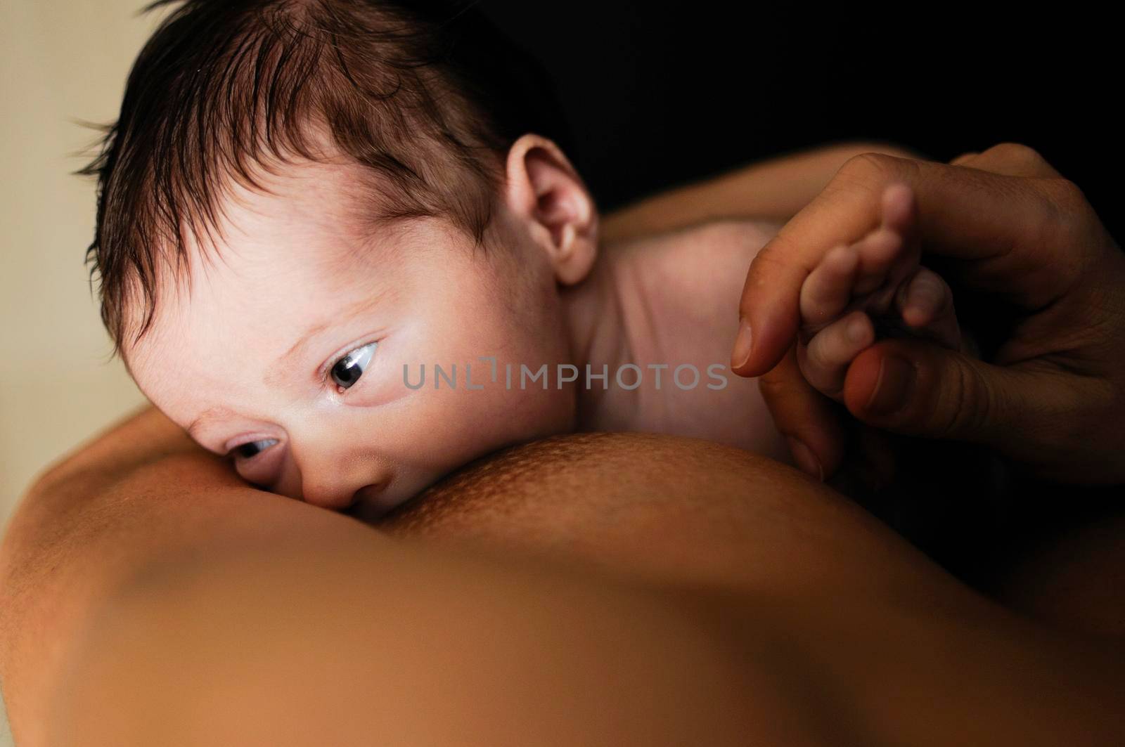 Young mother breastfeeding newborn baby by javiindy