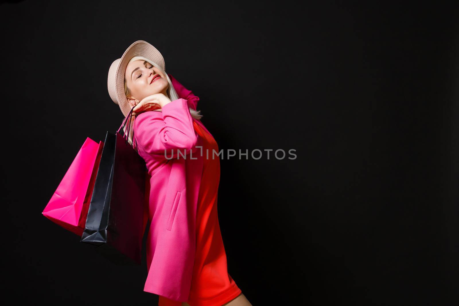 Shopping woman holding bags, isolated on black background. black friday concept by Andelov13
