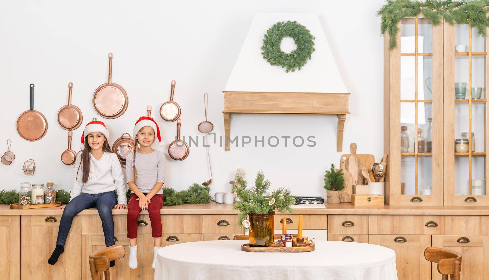 two little girls are waiting for christmas at home