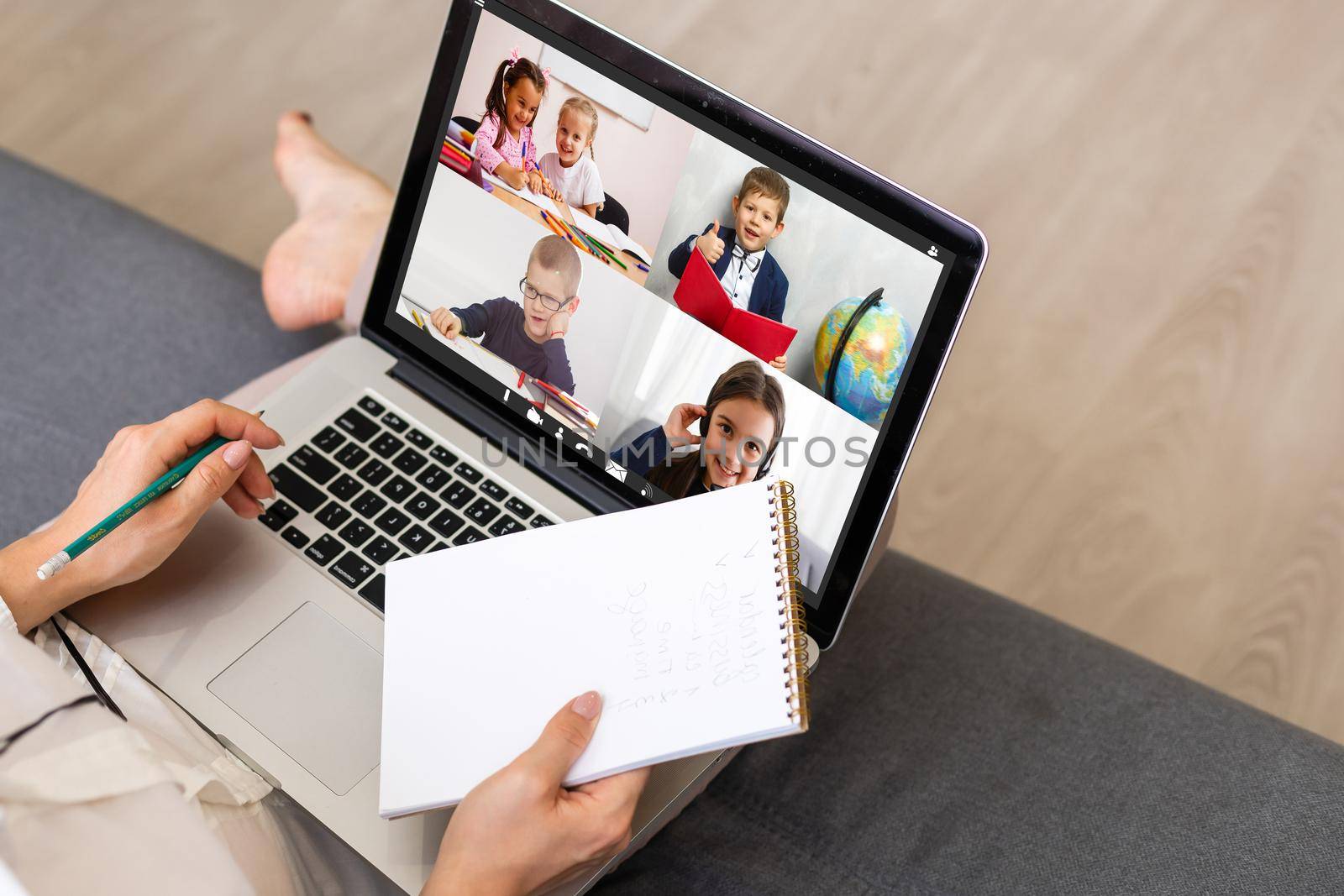 Back view of business woman talking to her colleagues about plan in video conference. Multiethnic business team using laptop for a online meeting in video call. Group of people smart working from home