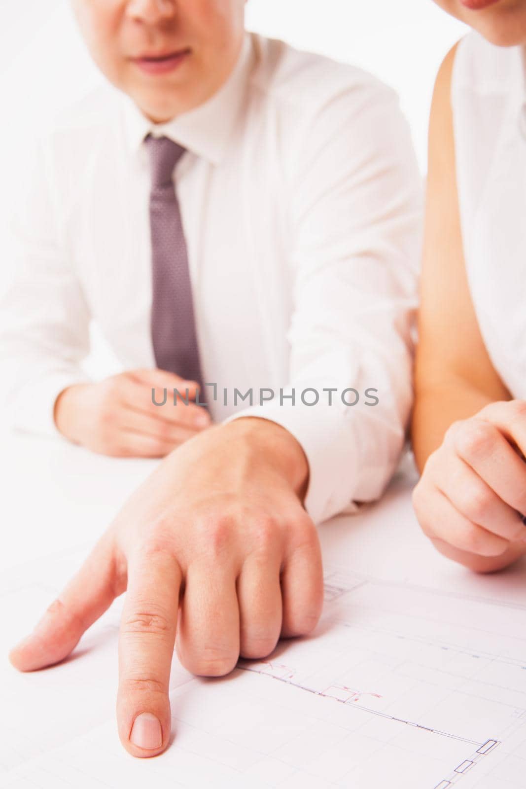 Businesswoman and businessman pointing at document in office isolated by Julenochek