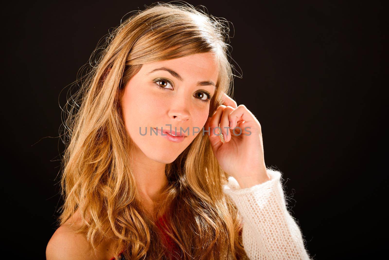 Portrait of a young blonde woman studio portrait on black background