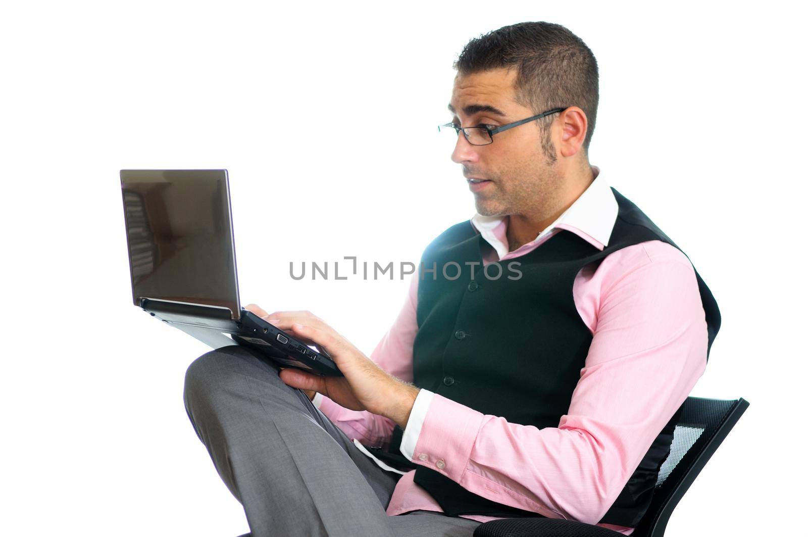 Successful businessman with glasses wearing vest and pink shirt looking at a little computer by javiindy