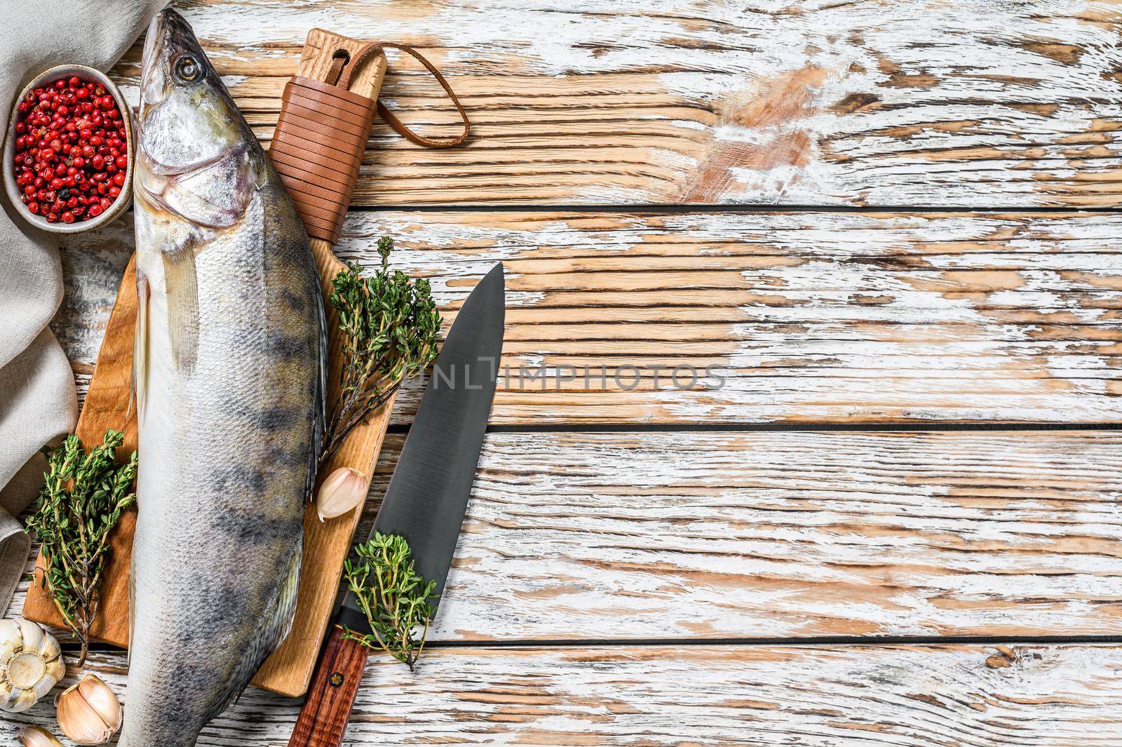 Fresh Zander, walleye with herbs. Raw fish. White background. Top view. Copy space by Composter