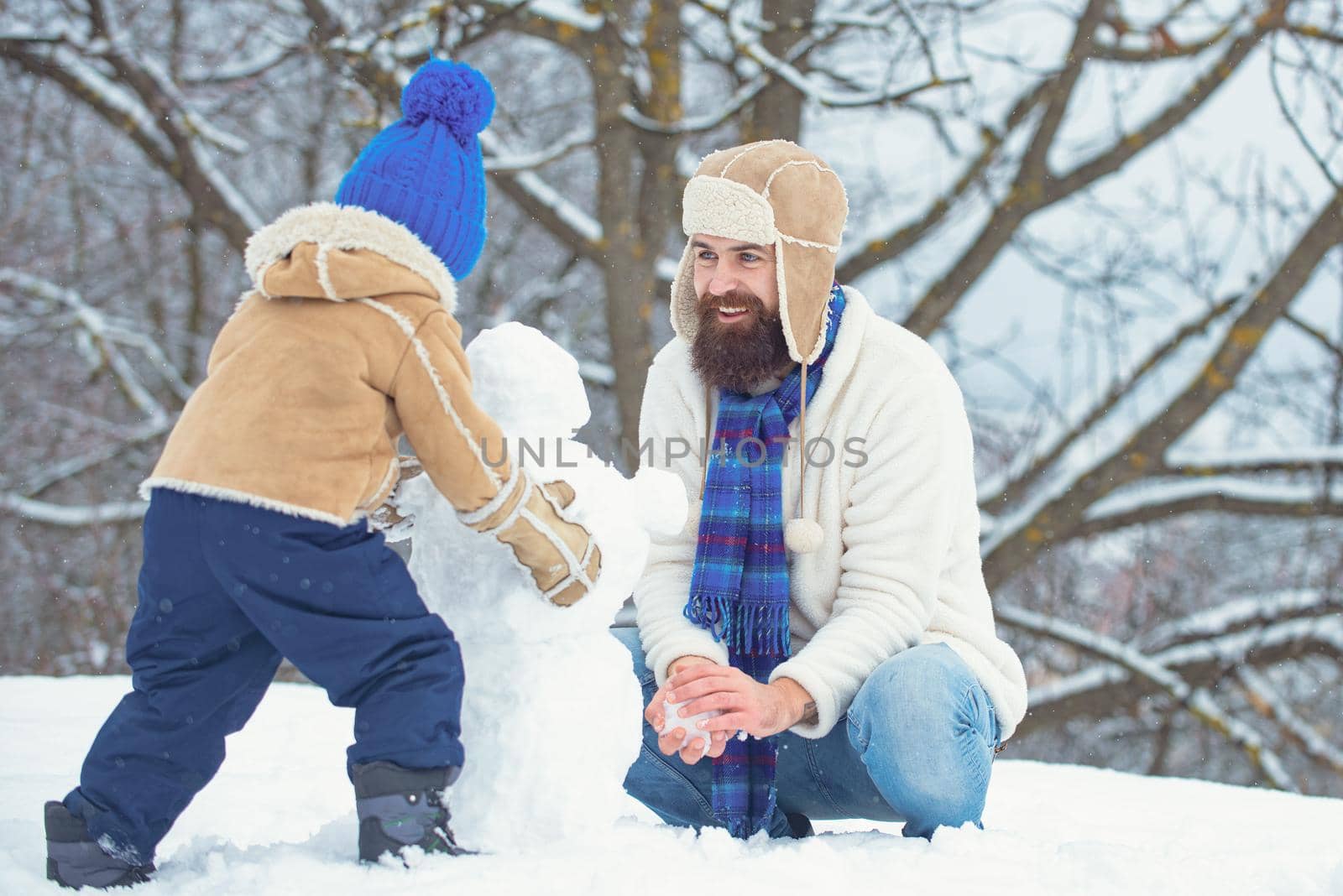Winter, father and son play outdoor. Merry Christmas and Happy new year. by Tverdokhlib