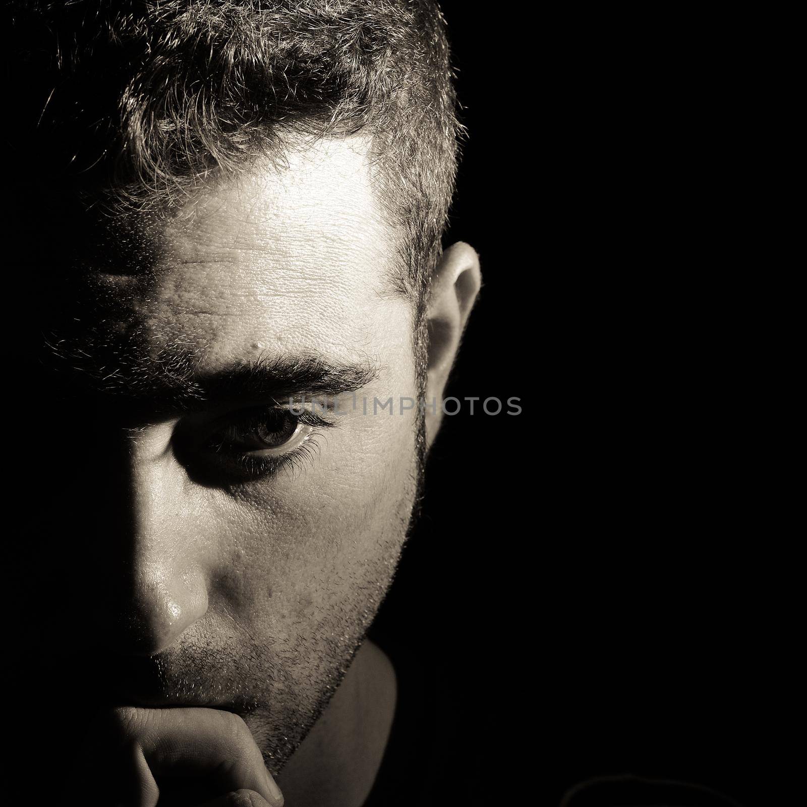 Portrait of a man with half face on shadow by javiindy