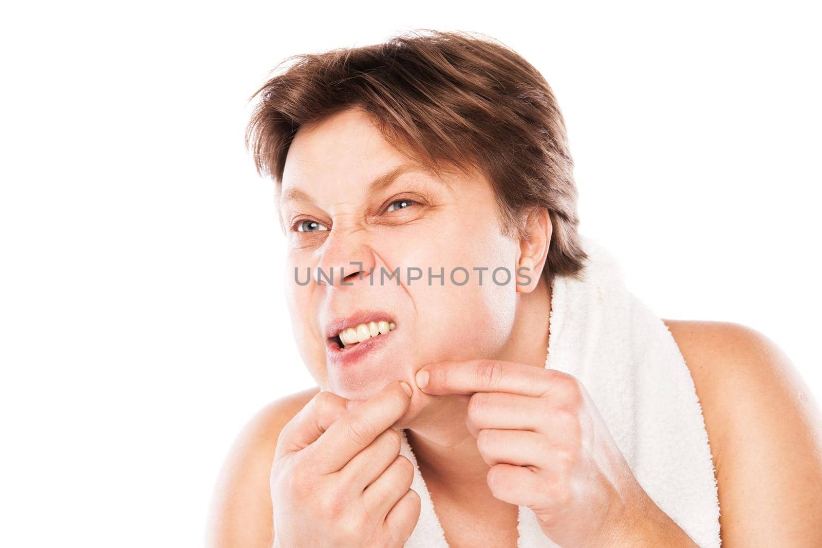 Man examining his stubble in mirror isolated over white