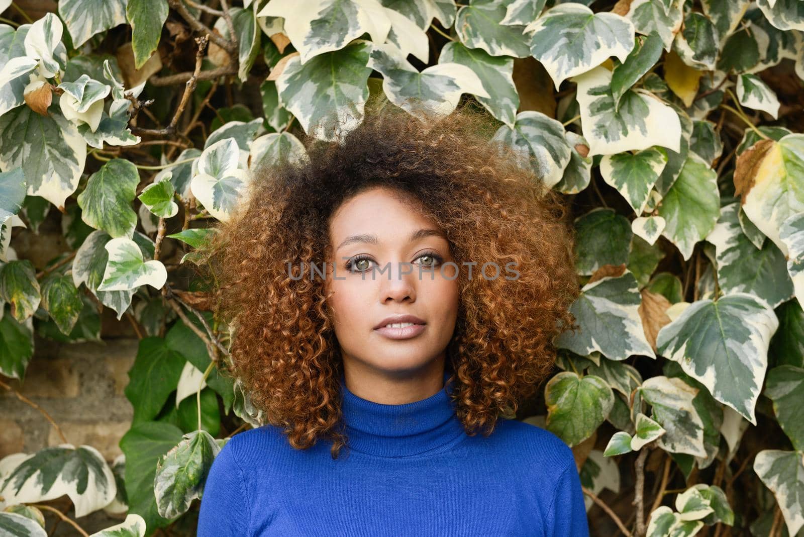 Young girl with afro hairstyle in urban background by javiindy