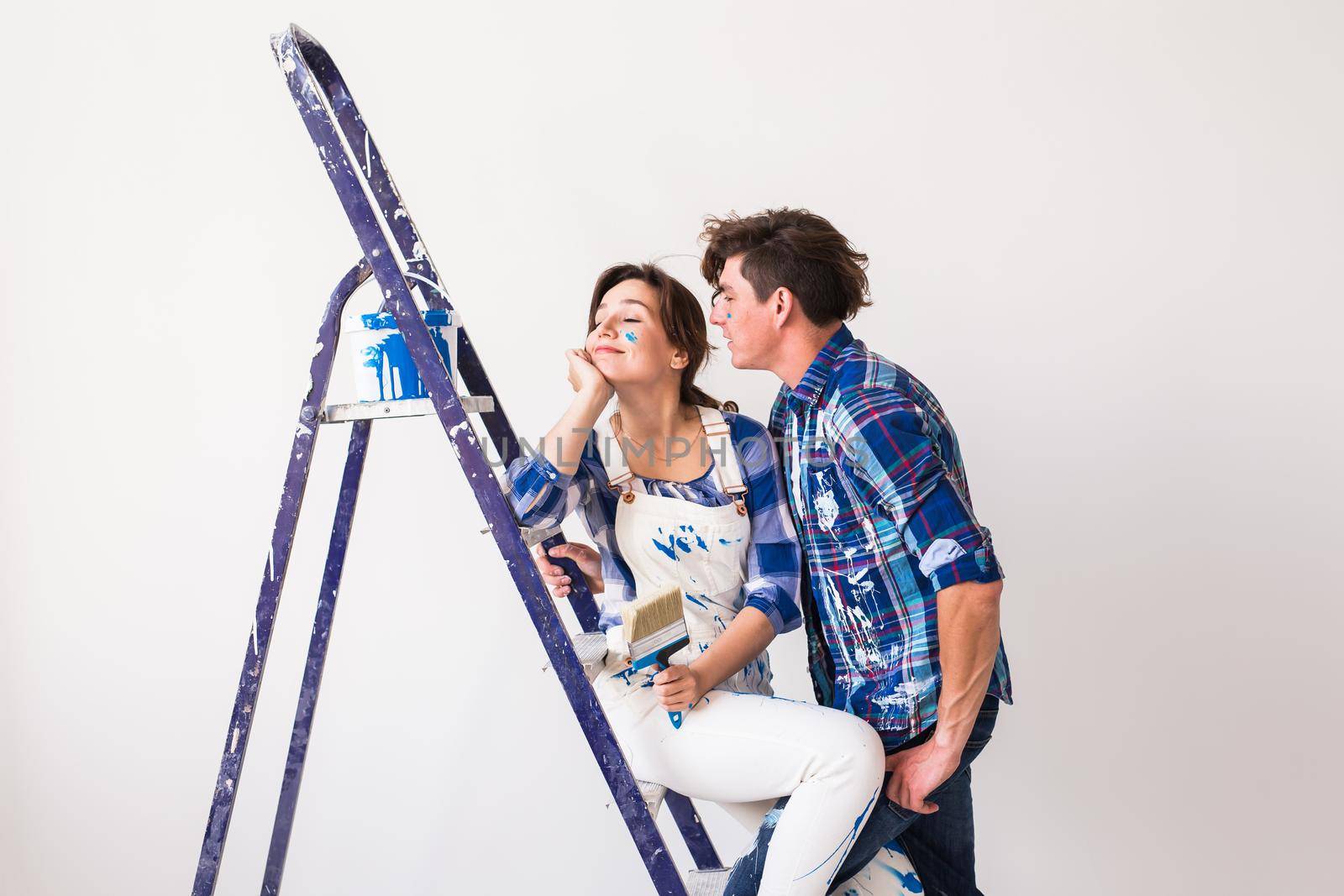 People, renovation and repair concept - Portrait of lovely couple doing redecoration in apartment.