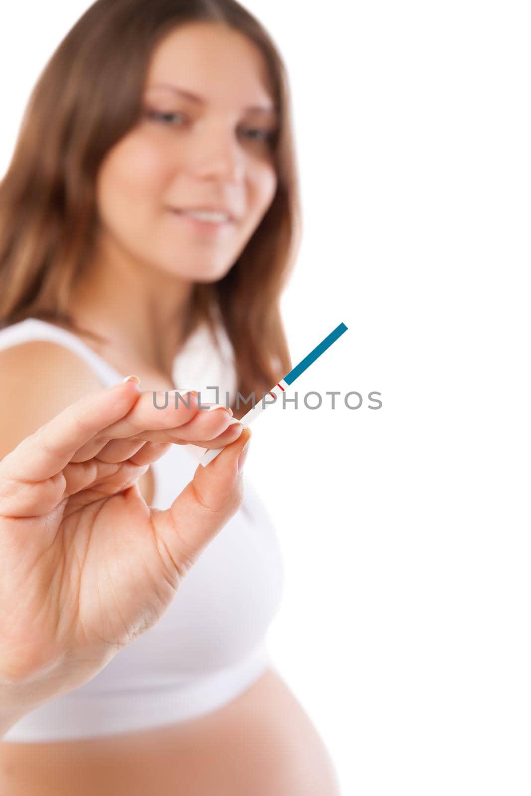 Smiling young woman looking on pregnancy test by Julenochek