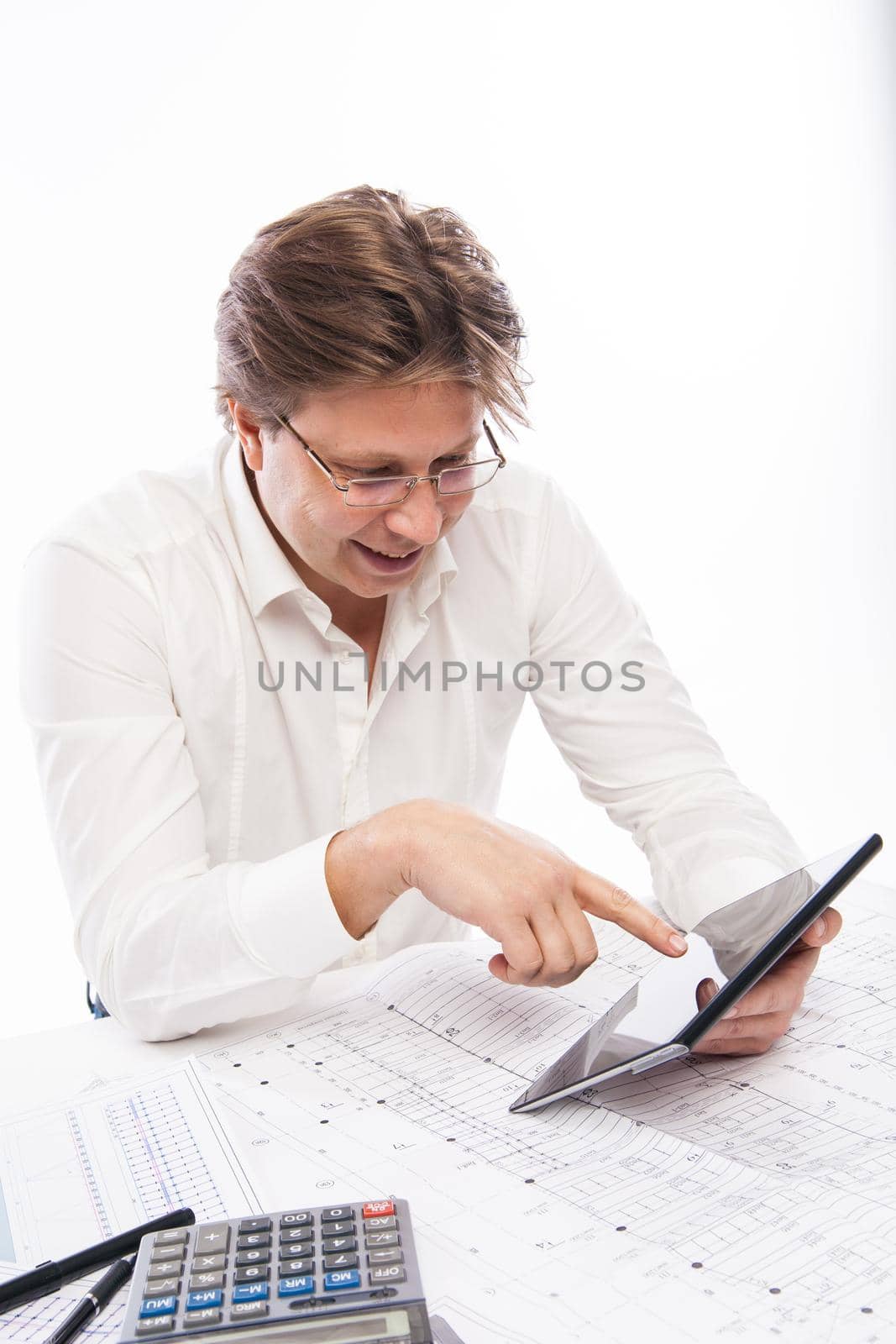 Businessman using tablet PC in office isolated over white. Draft on table