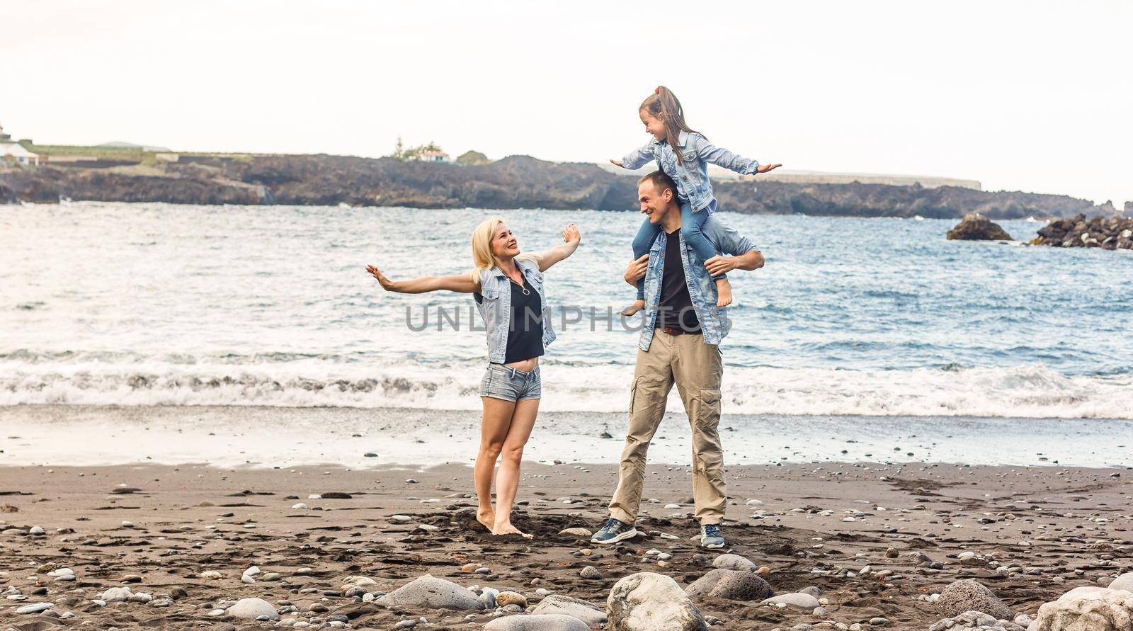 happy family with child daughter girl by the sea, spring