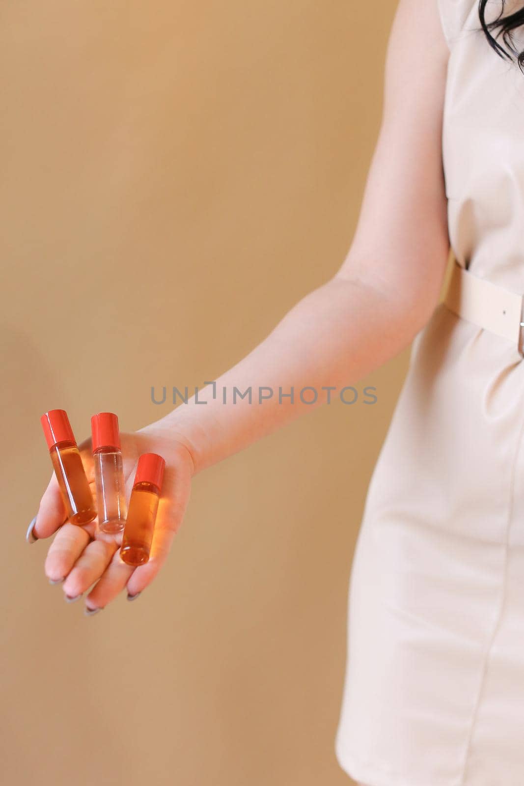 elegant sensual young woman holding perfume, golden tones by sisterspro