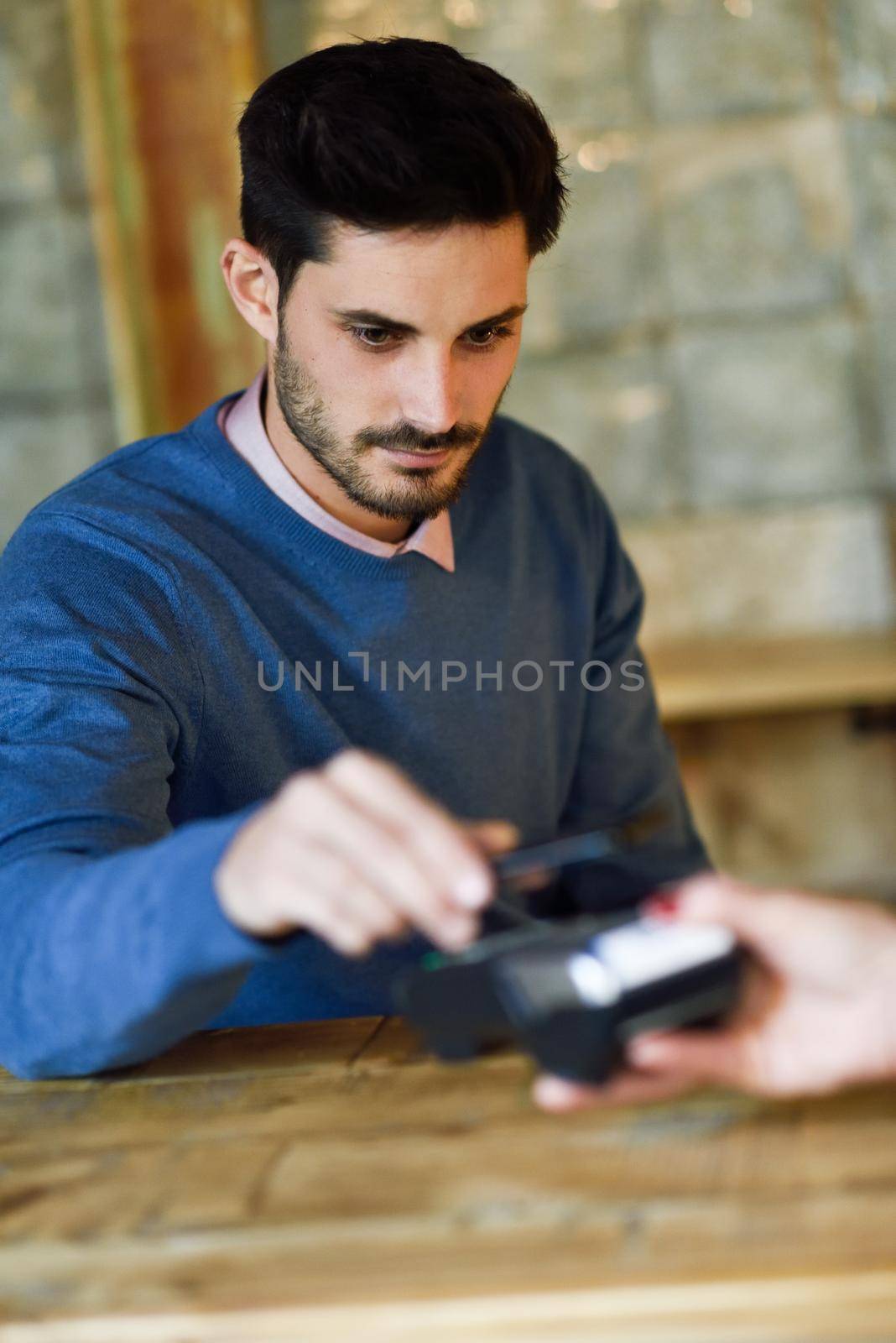 NFC Near Field Communication Mobile Payment. Hand holding smartphone paying on EDC machine.