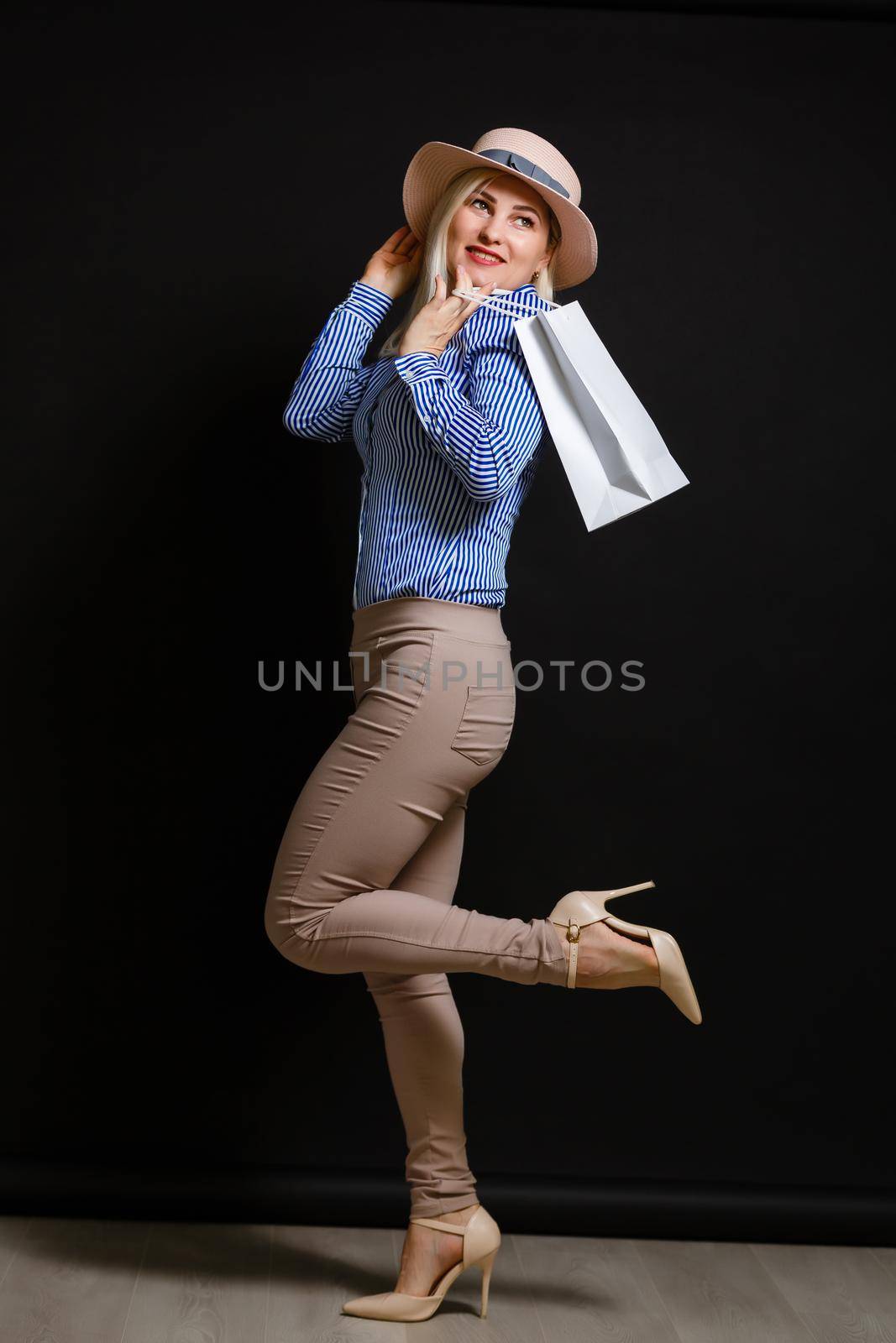 Elegant woman holding shopping bags, black friday concept