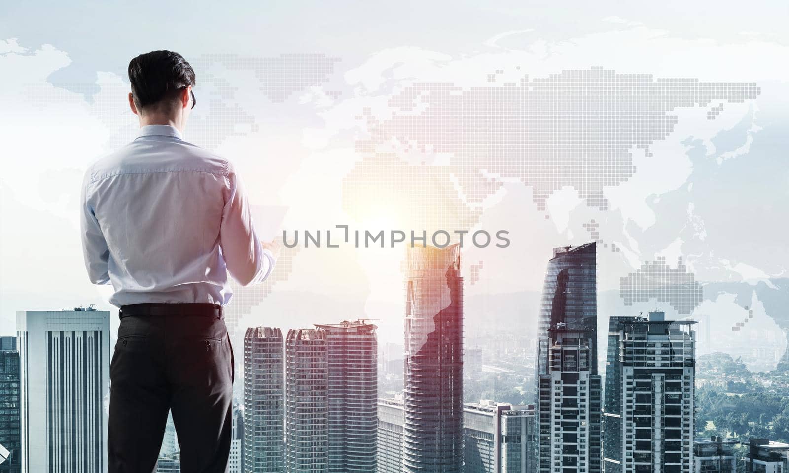 Young elegant businessman standing with back looking at business city