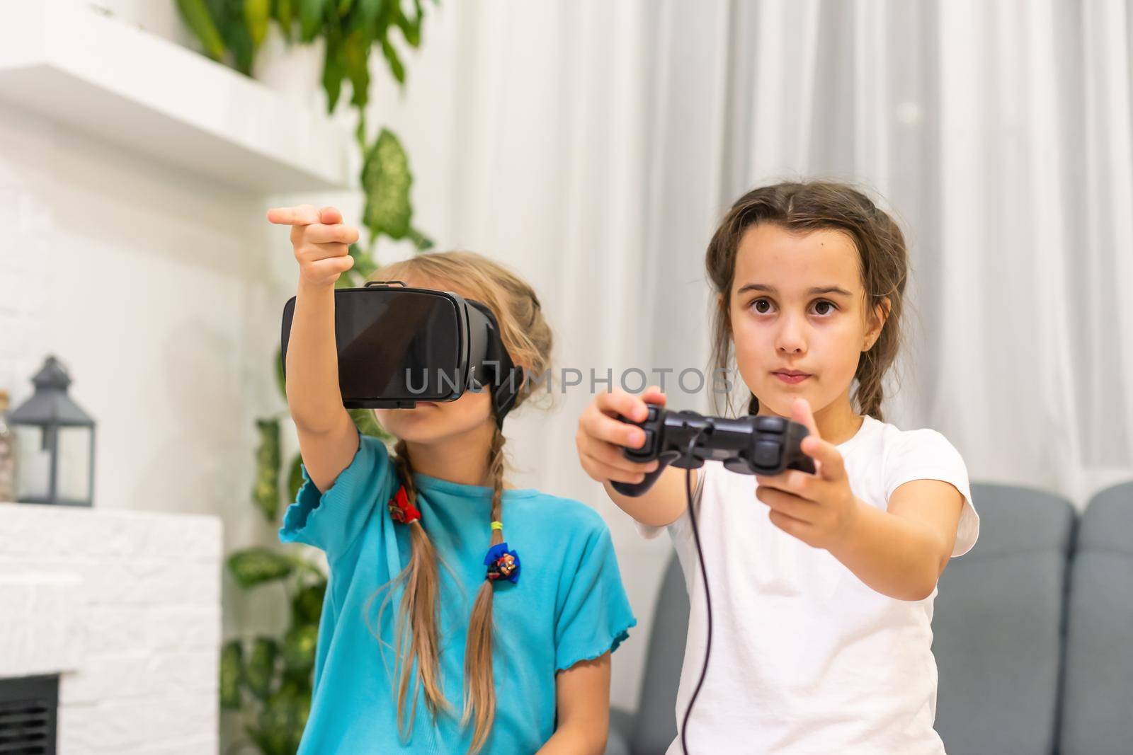 two little girls playing video games virtual reality glasses
