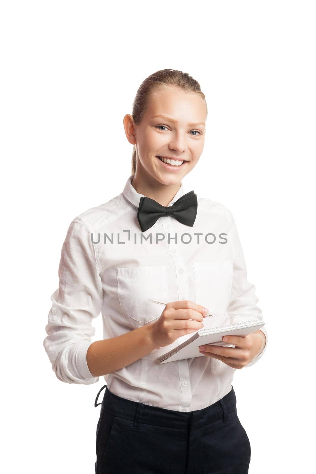 Portrait of cheerful waitress in uniform taking order while looking at camera.Studio shot