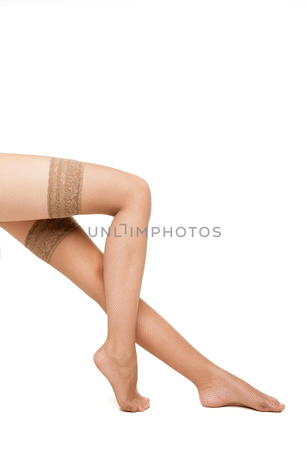 Close-up of unrecognizable sitting woman in beige hoses