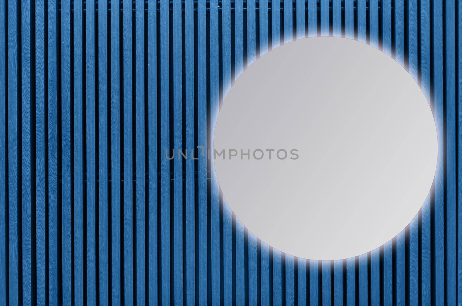round mirror on blue background