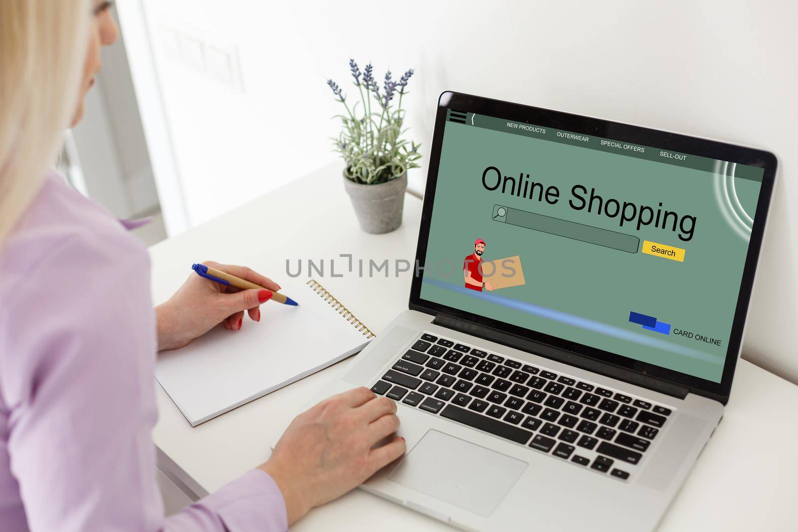 Online shopping website on laptop screen with female hands typing