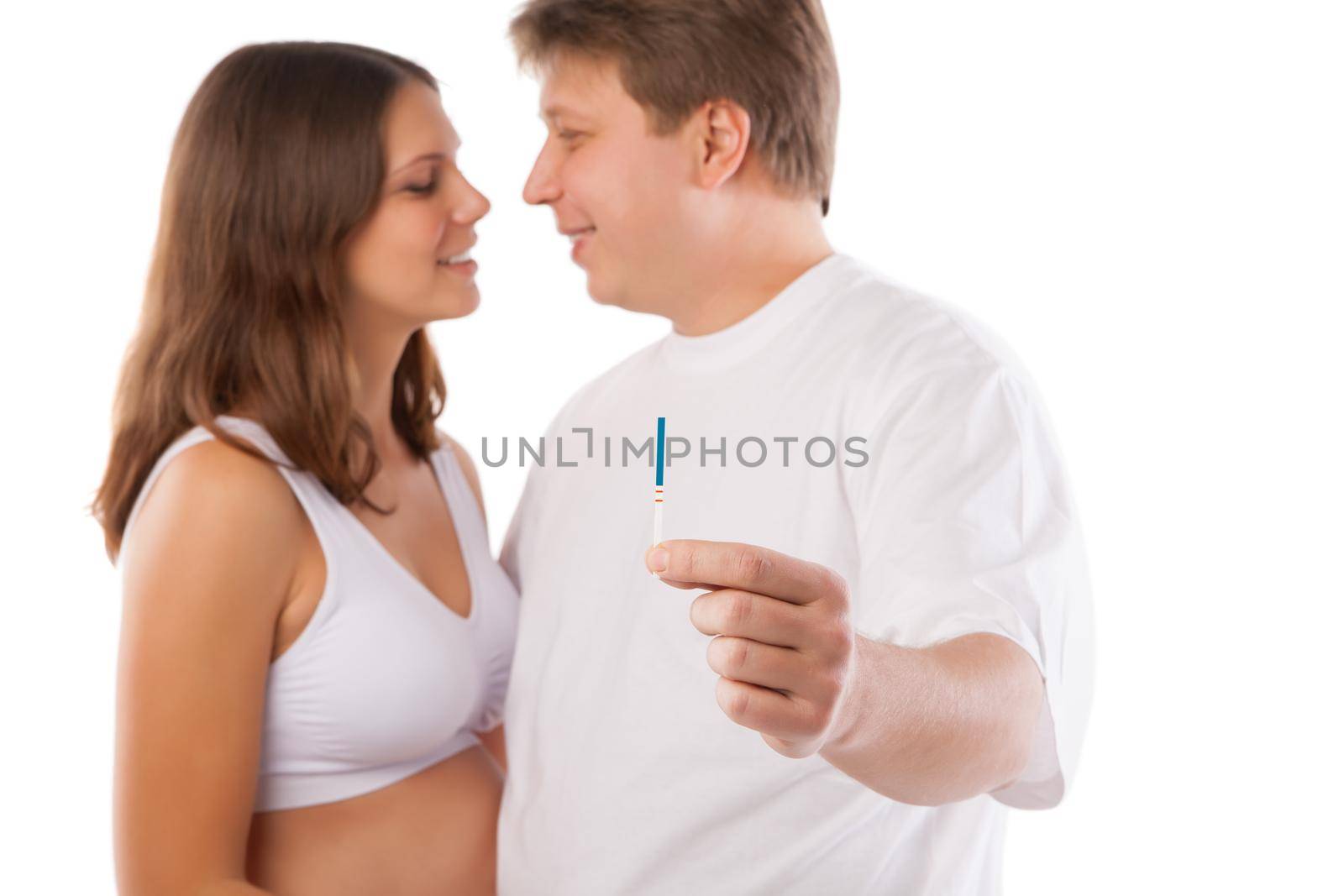 Joyful couple with positive pregnancy shown in the test device
